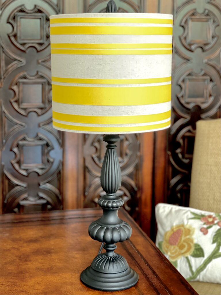A DIY yellow ribbon lampshade for my Primary Bedroom desk. A custom lampshade made using ribbon, 3M ATG Transfer Tape to apply the ribbon, and painters tape as guides for making pereclty straight and even lines.  