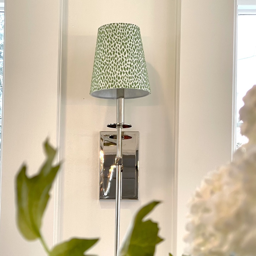 Lampshade covered in green animal print fabric from Thibaut add the right contrast to white walls.