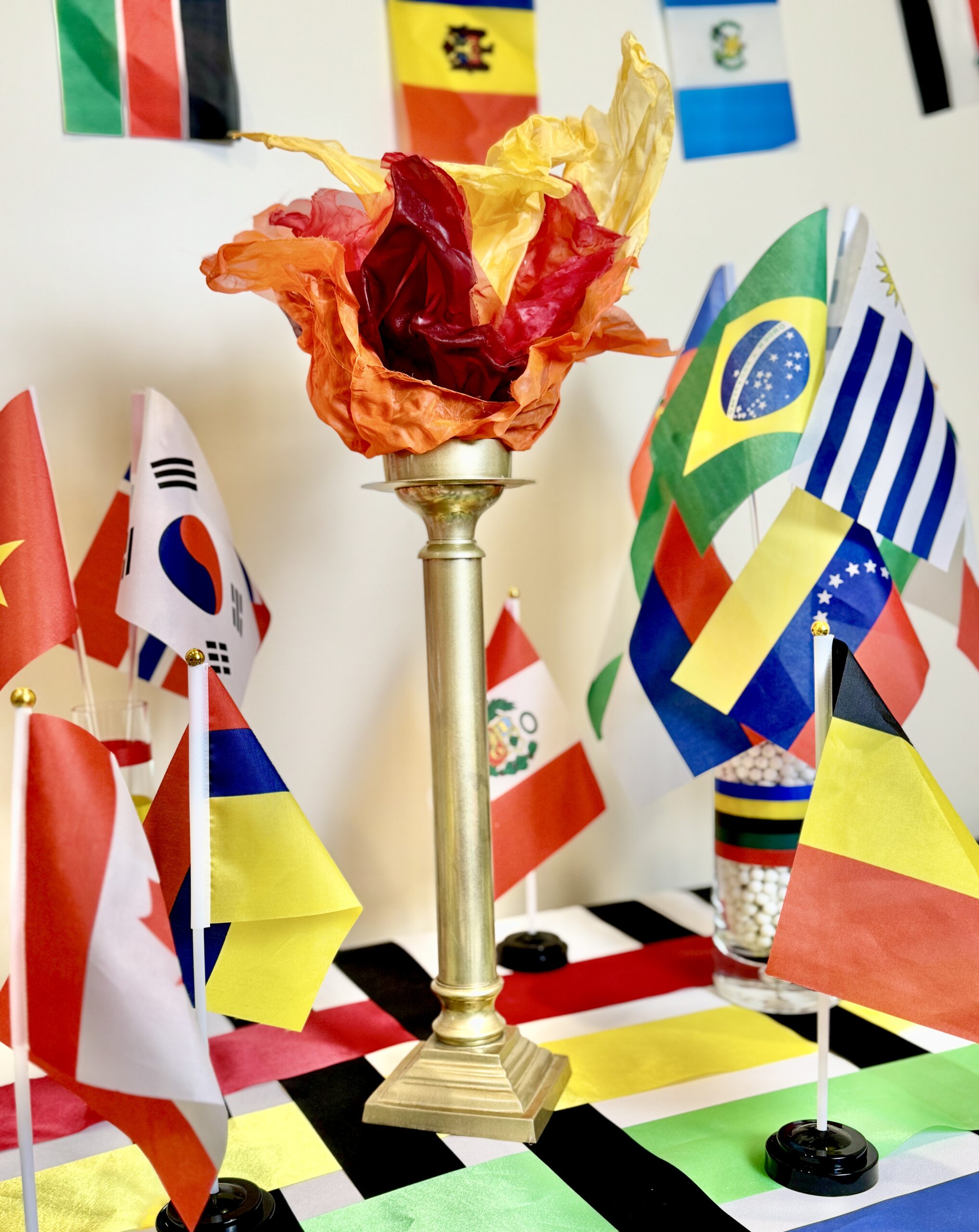 DIY Olympic Torch with Faux Flames. Olympic tablescape with Olympic theme tablecloth