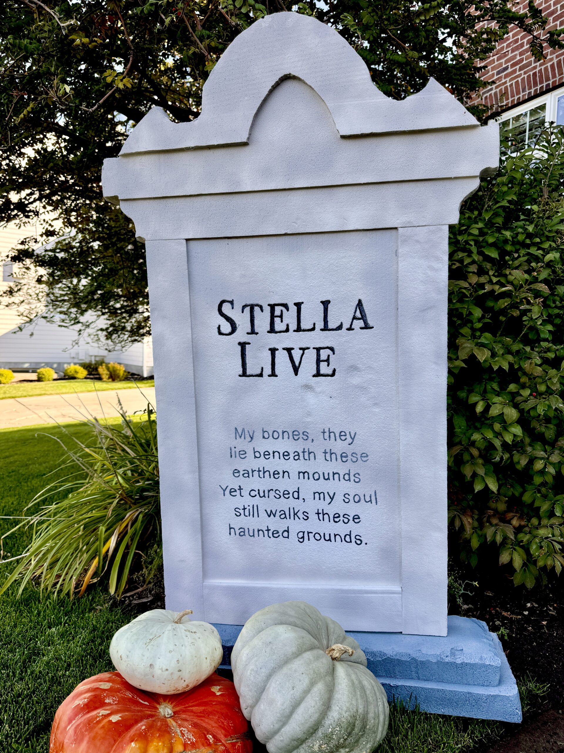 A large, life sized graveyard headstone made from styrofoam. It looks very realistic. Three different colors of grey spray paint merge to create a very realistic stone appearance.