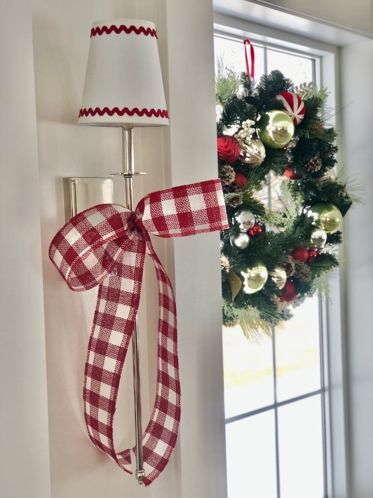 Buffalo checked plaid bows on long silver sconces of polished nickel. Lampshades are trimmed in red rick-rack for the Christmas Holiday.