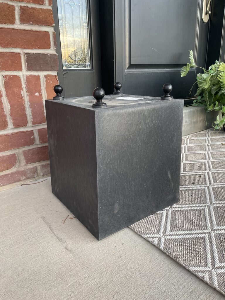 Drawer knobs create finials in each corner of the square base pot.