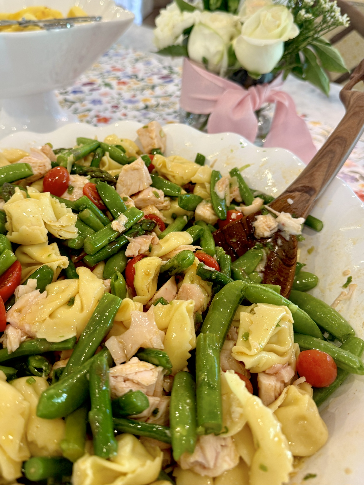 Salad made with ravioli pasta, fresh, in season veggies and a homemade tangy sweet dressing,