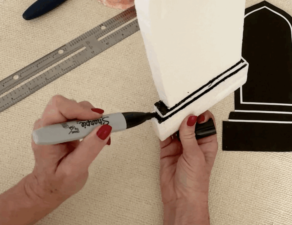 Using a Sharpie marker to enhance the details on the foam headstone.