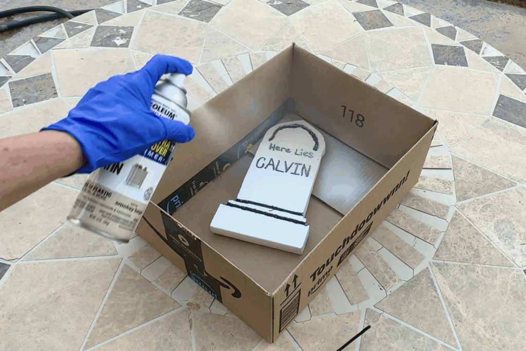 Spray paint the foam headstone with two or three different stone color shades.